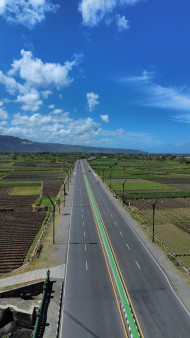 Scenic Aerial View of Rural Highway under Blue Sky