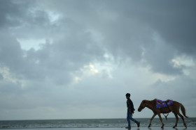 The horse rider on the beach.